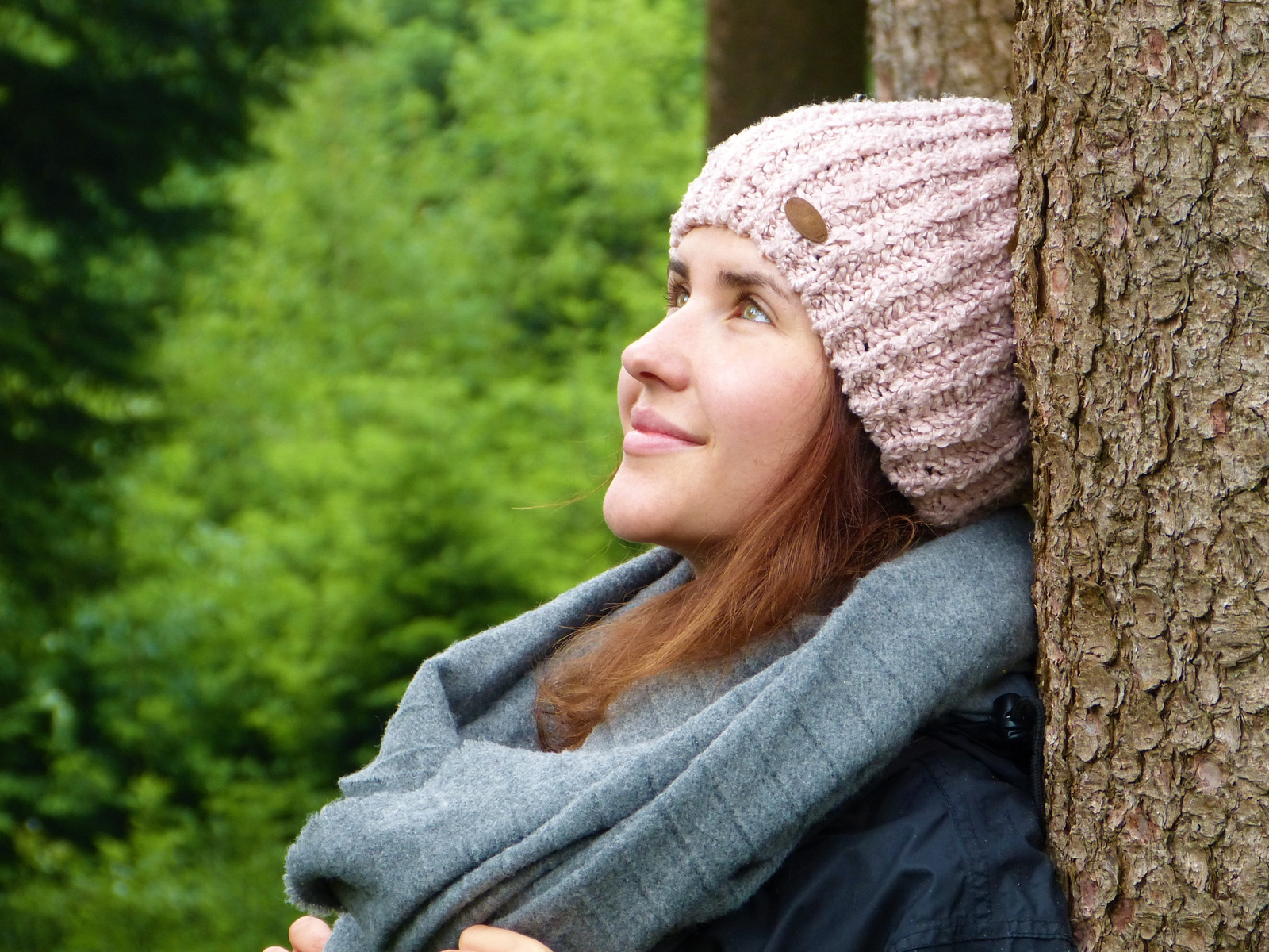 Woman Wearing Winter Clothes Leaning on the Tree